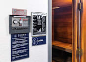 Thumbnail 4 of 10 - A wall with a sign that says "Caution To Avoid A Fire Risk On Conductive Materials" and another sign that says "Finnleo Sana".