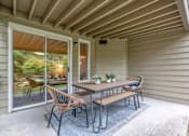 Thumbnail 5 of 10 - A patio with a table and chairs is shown.