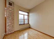 Thumbnail 13 of 23 - A room with a brick wall and a window.