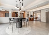 Thumbnail 39 of 39 - A modern kitchen with a bar area and a dining table.