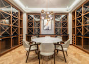 Thumbnail 34 of 39 - A dining room with a round table and chairs.