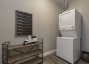 Thumbnail 8 of 11 - A white oven is in a kitchen next to a shelf with a chalkboard on the wall.