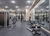 Thumbnail 21 of 28 - a gym with weights and cardio equipment and a large glass wall