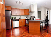 Thumbnail 12 of 20 - a kitchen with wooden cabinets and stainless steel appliances