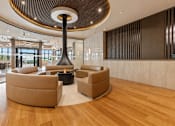 Thumbnail 1 of 40 - A modern living room with a large circular light fixture and two round sofas.