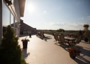 Thumbnail 17 of 18 - a roof terrace with tables and chairs and a view of the sky