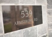 Thumbnail 18 of 18 - a metal sign on the side of a brick building