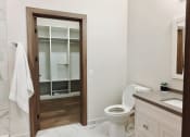 Thumbnail 8 of 17 - a bathroom with white cabinets and a black sink at 150 Marketplace, Ontario