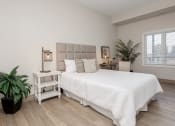 Thumbnail 7 of 17 - a bedroom with a bed and a mirror at 150 Marketplace, Ottawa, ON