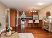Thumbnail 4 of 22 - A kitchen with wooden cabinets and a white refrigerator.