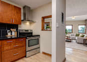 Thumbnail 11 of 29 - A kitchen with wooden cabinets and a stainless steel oven.