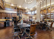 Thumbnail 23 of 28 - A large dining room with a wooden table and chairs.