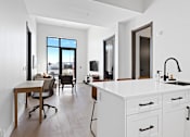 Thumbnail 8 of 24 - A modern kitchen with white cabinets and a large window at The Woods at 180 Kanata Avenue, Kanata, K2K 3L9