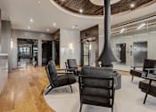 Thumbnail 32 of 34 - A modern living room with a curved ceiling and wooden floors at The Woods at 180 Kanata Avenue Apartments, Kanata, K2T 0T4