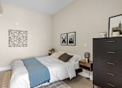 Thumbnail 9 of 24 - A bedroom with a white bed and a blue blanket at The Woods at 180 Kanata Avenue, Kanata, Ontario