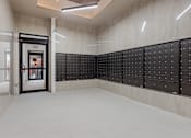 Thumbnail 34 of 34 - A room with a white floor and a wall of black lockers at The Woods at 180 Kanata Avenue Apartments, Kanata