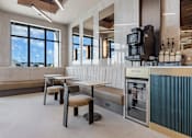 Thumbnail 26 of 34 - A modern cafe with a counter and seating area at The Woods at 180 Kanata Avenue Apartments, Kanata, Ontario