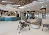 Thumbnail 30 of 34 - A modern waiting area with chairs and a bar at The Woods at 180 Kanata Avenue Apartments, Kanata, ON K2T 0T4
