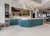 Thumbnail 24 of 34 - A modern bar with a blue counter and a black stove at The Woods at 180 Kanata Avenue Apartments, Kanata, ON