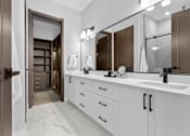 Thumbnail 5 of 24 - A bathroom with a white counter and a brown door at The Woods at 180 Kanata Avenue, Kanata