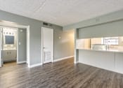 Thumbnail 8 of 19 - A room with a wooden floor and white walls.