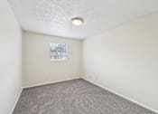 Thumbnail 42 of 55 - A room with a window and carpeted floor.