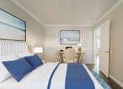 Thumbnail 6 of 12 - a bedroom with a bed and a desk  at North Washington Apartments