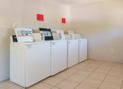 Thumbnail 8 of 12 - a row of washers and dryers in a laundry room  at North Washington Apartments