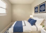 Thumbnail 7 of 12 - a bedroom with a bed and two paintings on the wall  at North Washington Apartments