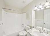 Thumbnail 35 of 55 - A white bathroom with a toilet, sink, and shower.