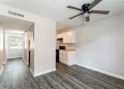 Thumbnail 5 of 20 - A room with a ceiling fan and a cabinet.