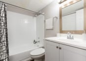 Thumbnail 11 of 20 - a bathroom with a sink toilet and bathtub, Timberfalls Apartments