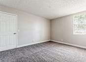 Thumbnail 9 of 20 - A room with a white door and a window with blinds.