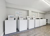 Thumbnail 15 of 21 - A series of white boxes are lined up in a room.