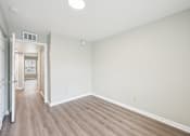 Thumbnail 13 of 55 - A room with a light brown floor and white walls.