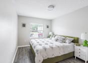 Thumbnail 20 of 31 - Bedroom with a bed and a window_Rolling Hills Apartments