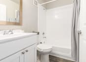 Thumbnail 21 of 31 - Bathroom with a sink, toilet and bathtub_Rolling Hills Apartments