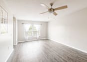 Thumbnail 24 of 31 - Empty living room with a ceiling fan_Rolling Hills Apartments