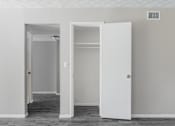 Thumbnail 8 of 18 - A white door is open to a room with a white wall and a vent.