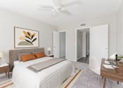 Thumbnail 9 of 18 - A bedroom with a large bed, a painting on the wall, and a ceiling fan.
