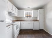 Thumbnail 5 of 18 - a kitchen with white appliances and white cabinets at Jacksonville Heights Apartments