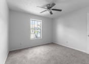 Thumbnail 10 of 18 - bedroom with a ceiling fan and a window at Jacksonville Heights Apartments
