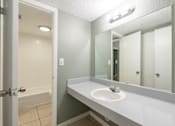 Thumbnail 12 of 19 - a bathroom with a sink and a bathtub at Bella Mar Apartments