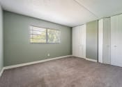 Thumbnail 11 of 19 - a bedroom with two closets and a carpeted floor at Bella Mar Apartments