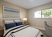 Thumbnail 5 of 13 - A bedroom with a large bed and a painting on the wall.