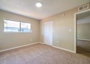 Thumbnail 7 of 13 - A room with a window and a door.