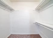 Thumbnail 8 of 13 - A white wall with a brown carpet.