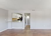 Thumbnail 3 of 17 - a living room with a kitchen in the background