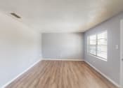 Thumbnail 11 of 17 - a bedroom with hardwood floors and grey walls