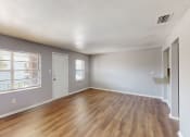 Thumbnail 5 of 17 - a living room with hardwood floors and grey walls